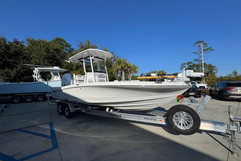 Slide: The Image of 2026 Caymas 26 HB boat on trailer, parked outdoors under clear blue sky. - 8