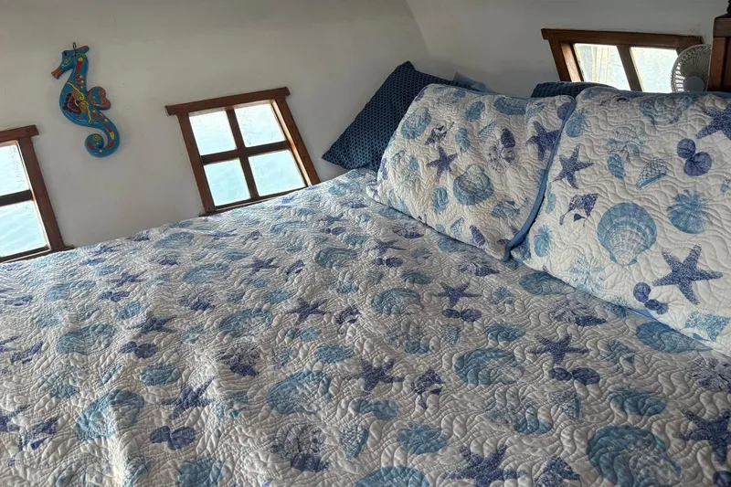 Slide: The Image of Cozy bedroom in 1972 Islander 40MS with nautical-themed bedding and seahorse decor. - 10