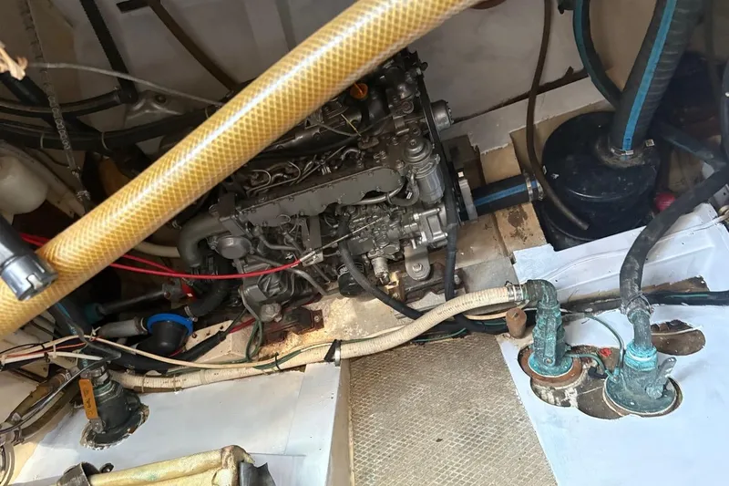 Slide: The Image of Engine compartment of a 1972 Islander 40MS sailboat, showing mechanical components and hoses. - 15