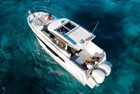 Slide: The Image of Manufacturer Provided Image: 2026 Jeanneau NC 895 Series 2 cruising on clear blue water, aerial view. - 2
