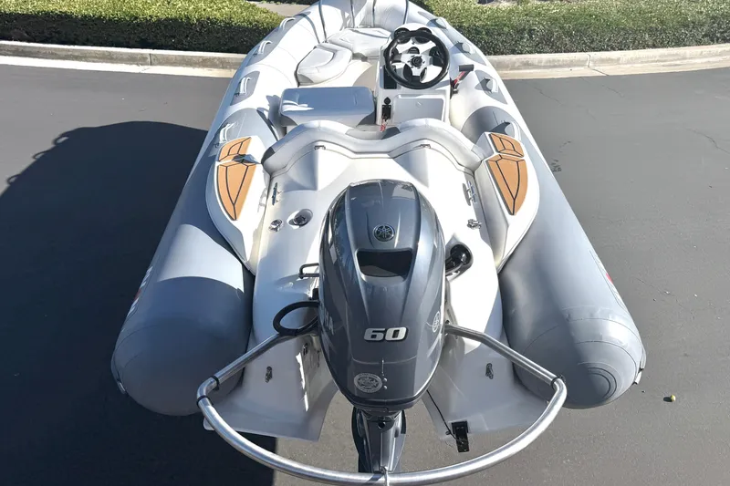 Slide: The Image of 2017 Avon Seasport 420 inflatable boat with Yamaha 60 engine, parked on pavement. - 19