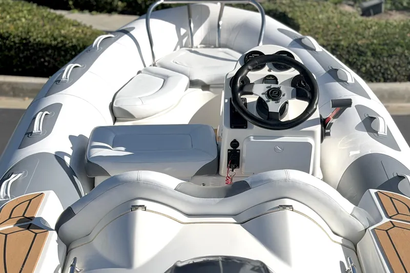 Slide: The Image of 2017 Avon Seasport 420 boat interior with steering wheel and seating. - 20