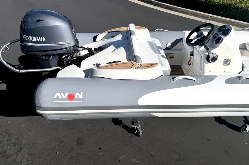Slide: The Image of 2017 Avon Seasport 420 inflatable boat with Yamaha outboard motor, parked on pavement. - 22