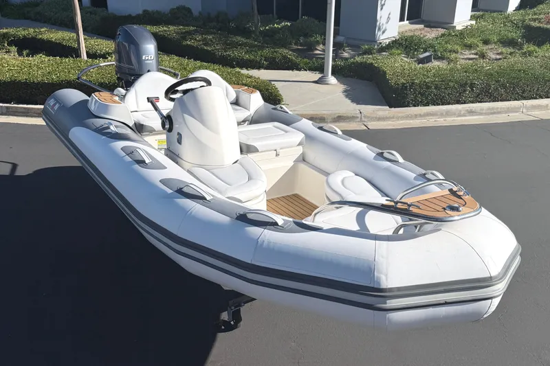 Slide: The Image of 2017 Avon Seasport 420 inflatable boat with Yamaha 60 engine, parked on pavement. - 24