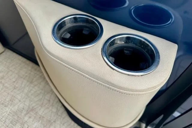 Slide: The Image of Cup holders in a 2019 Barletta E22QC boat, featuring beige upholstery. - 14