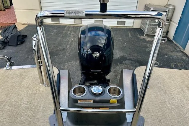 Slide: The Image of 2019 Barletta E22QC boat engine with stainless steel railing and cup holders. - 15