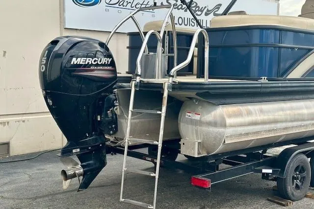 Slide: The Image of 2019 Barletta E22QC pontoon boat with Mercury outboard motor on trailer. - 3