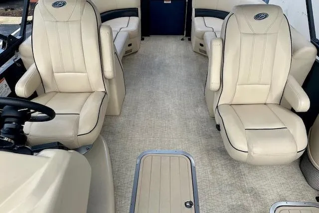 Slide: The Image of 2019 Barletta E22QC boat interior with beige seating and spacious layout. - 6