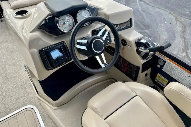 Slide: The Image of 2019 Barletta E22QC boat dashboard with steering wheel and gauges. - 8