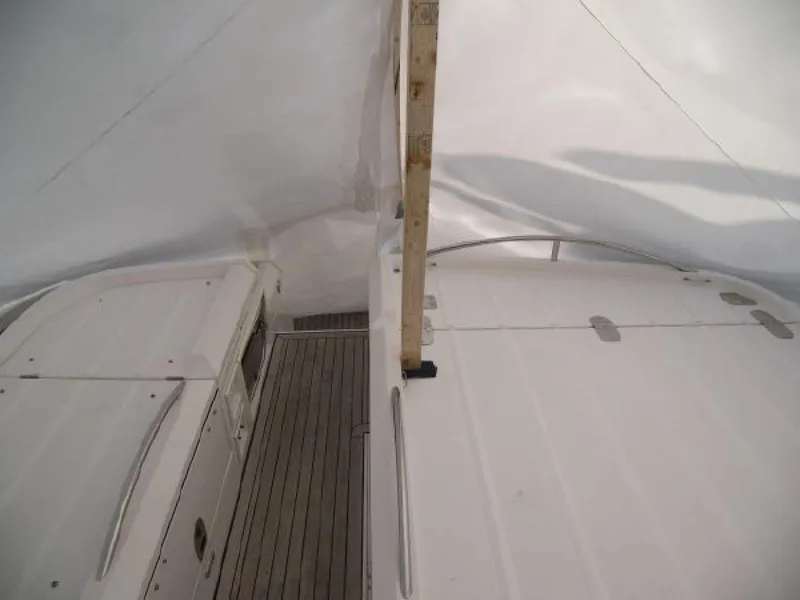 Slide: The Image of 2007 Fairline Targa 52 yacht under protective cover, showcasing deck and railing. - 18