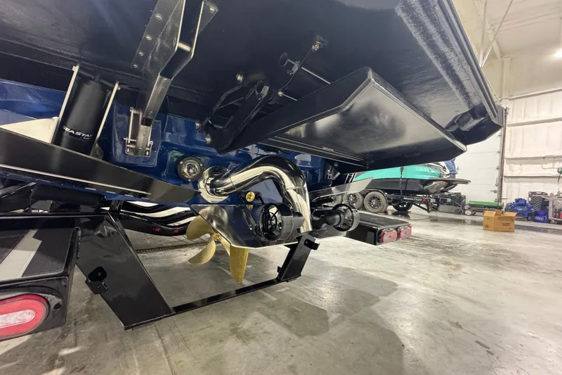 Slide: The Image of 2026 Supra SL 450 boat propeller and stern in a garage setting. - 7