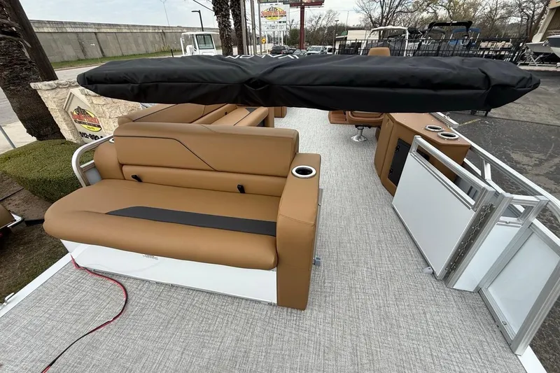Slide: The Image of 2026 Avalon VENTURE 85 CRUISE boat interior with tan seating and covered canopy. - 14