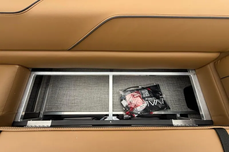 Slide: The Image of Under-seat storage in 2026 Avalon VENTURE 85 CRUISE with brown leather upholstery. - 23