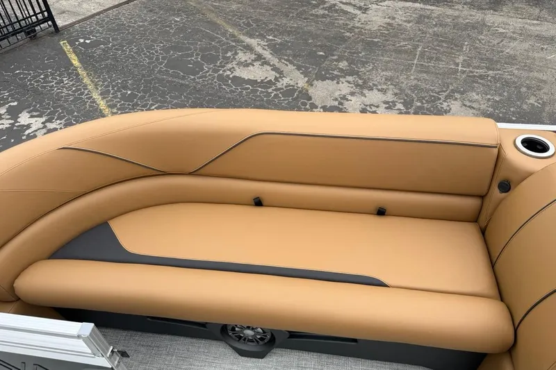 Slide: The Image of Luxurious seating on 2026 Avalon VENTURE 85 CRUISE boat, featuring tan upholstery and cup holder. - 38