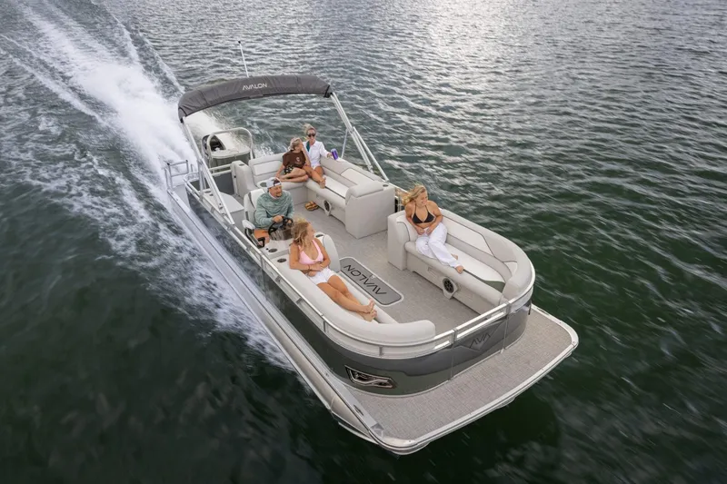 Slide: The Image of 2026 Avalon VENTURE 85 CRUISE pontoon boat with luxurious tan seating, parked outdoors. - 9