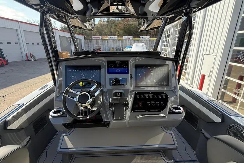 Slide: The Image of 2026 Sunsation 32 CCX boat dashboard with modern controls and dual screens. - 10