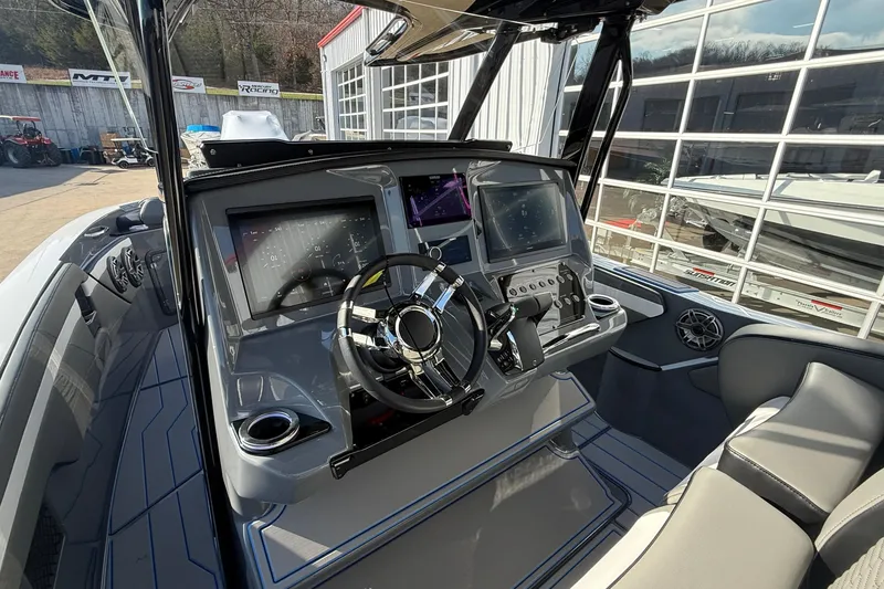 Slide: The Image of 2026 Sunsation 32 CCX boat cockpit with modern steering and digital displays. - 11