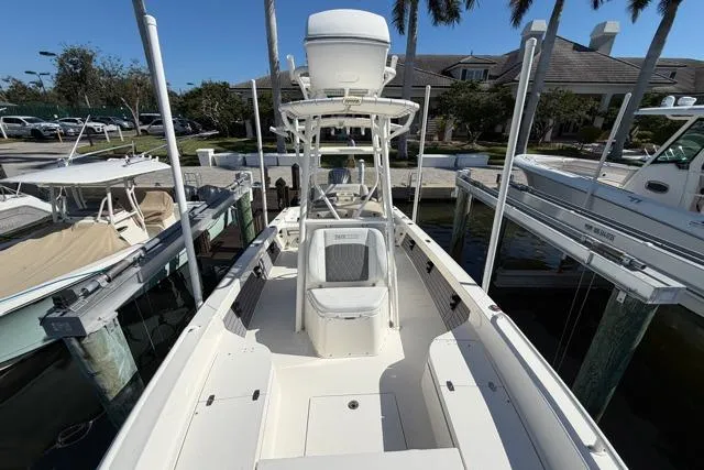Slide: The Image of 2023 Pathfinder 2600 TRS boat docked, featuring spacious deck and modern design. - 12