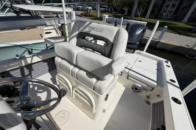 Slide: The Image of 2023 Pathfinder 2600 TRS boat interior with cushioned seating and steering wheel. - 17