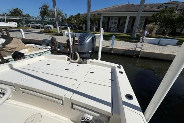 Slide: The Image of 2023 Pathfinder 2600 TRS boat docked at marina with outboard motor. - 18
