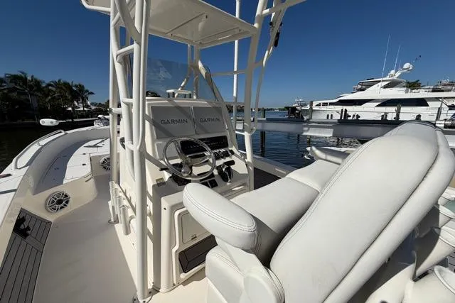 Slide: The Image of 2023 Pathfinder 2600 TRS boat interior with Garmin navigation, docked by luxury yachts. - 20