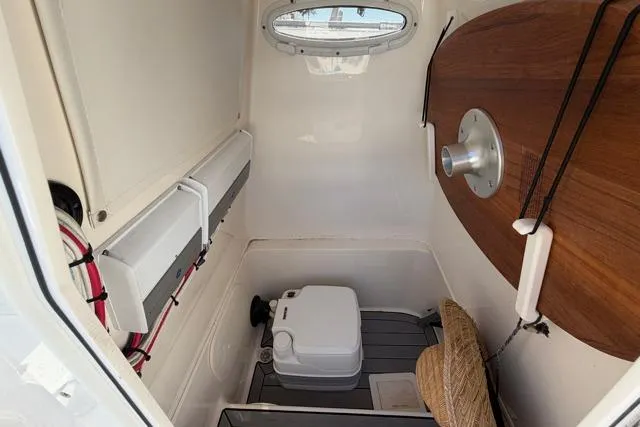 Slide: The Image of 2023 Pathfinder 2600 TRS boat interior with compact toilet and storage area. - 21