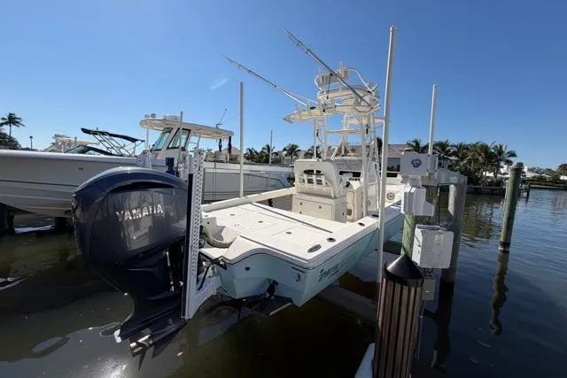 Slide: The Image of 2023 Pathfinder 2600 TRS boat docked with Yamaha outboard motor, clear sky background. - 24
