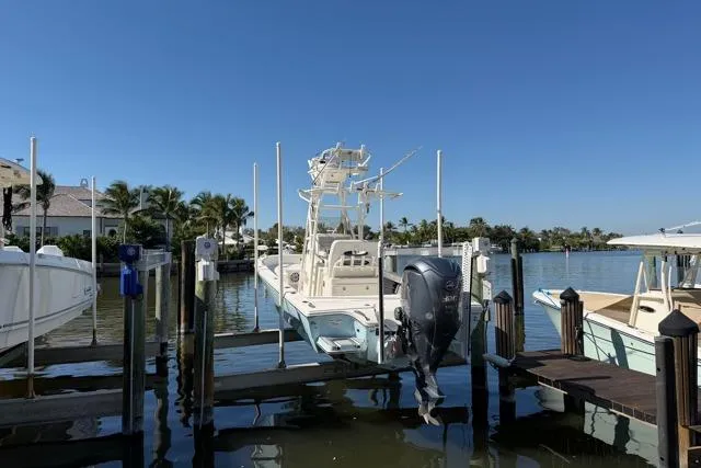 Slide: The Image of 2023 Pathfinder 2600 TRS boat docked in a sunny marina setting. - 26