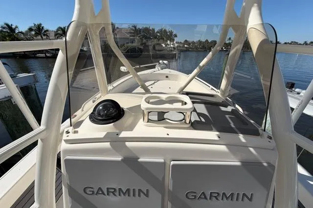 Slide: The Image of 2023 Pathfinder 2600 TRS boat with Garmin equipment, docked by a scenic waterfront. - 7