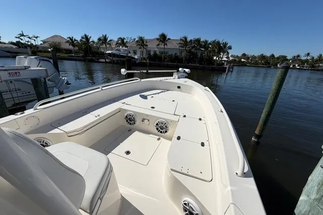 Slide: The Image of 2023 Pathfinder 2600 TRS boat docked by waterfront homes under clear blue sky. - 8
