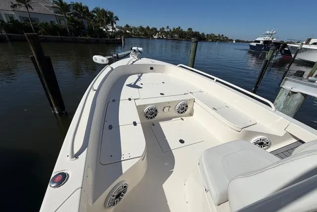 Slide: The Image of 2023 Pathfinder 2600 TRS boat docked by calm waters, featuring spacious seating and modern design. - 9
