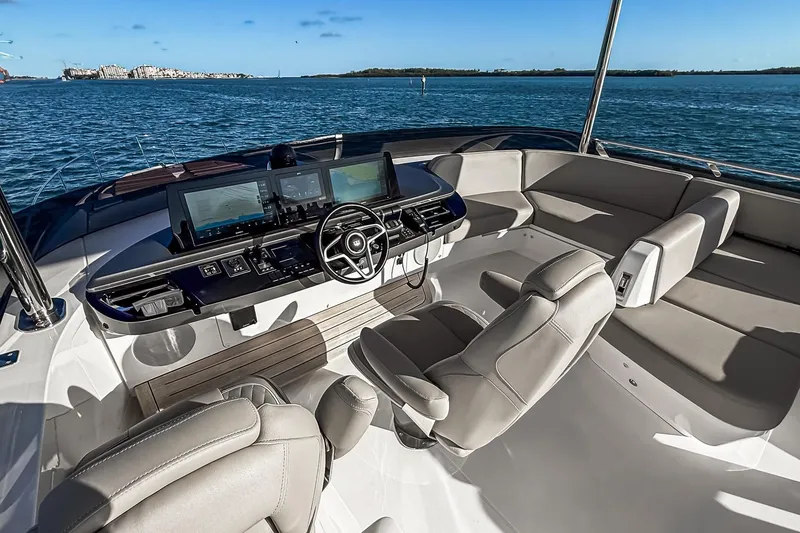 Slide: The Image of Luxurious 2026 Princess S65 Sportbridge yacht interior with modern navigation system and plush seating. - 103