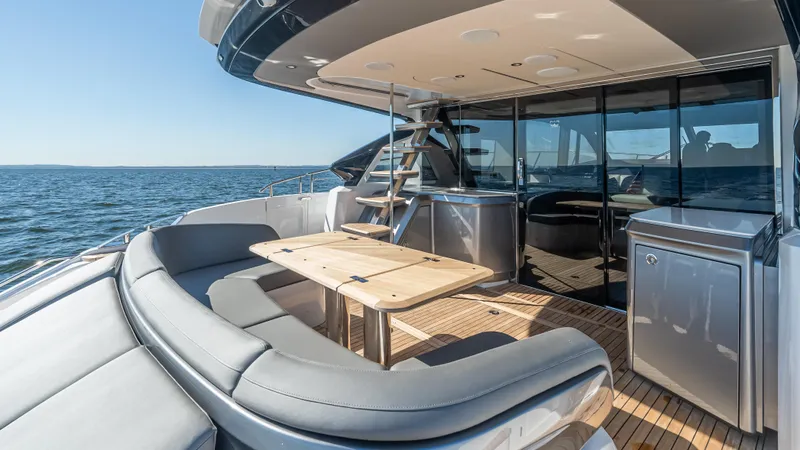 Slide: The Image of 2026 Princess S65 Sportbridge yacht with city skyline and sunlit deck. - 12