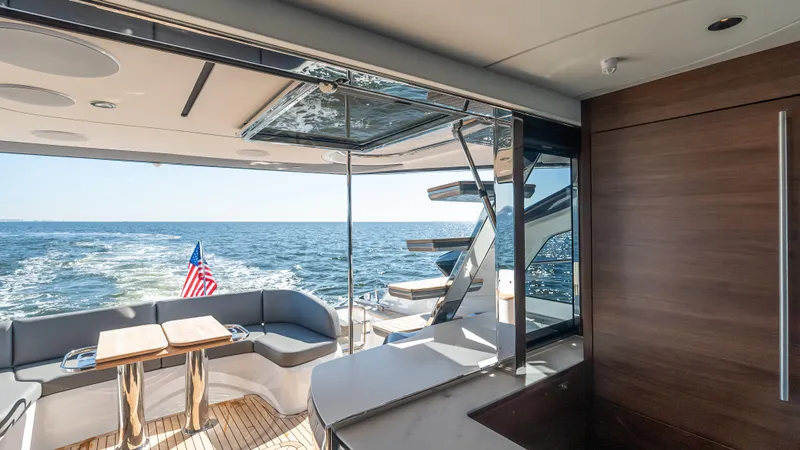 Slide: The Image of Luxurious 2026 Princess S65 Sportbridge yacht with American flag, ocean view. - 14