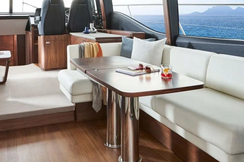 Slide: The Image of Luxurious 2026 Princess S65 Sportbridge yacht deck with seating, ocean view, and American flag. - 18