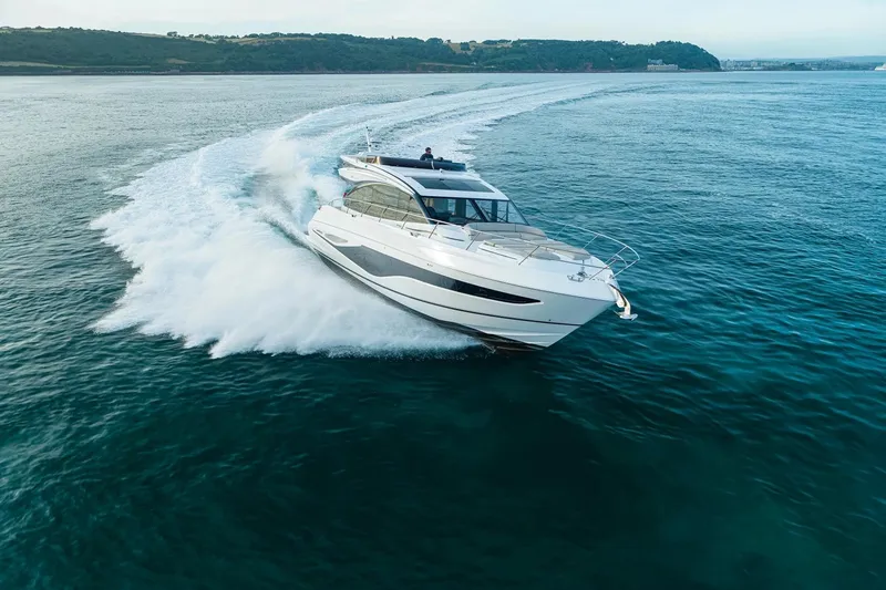 Slide: The Image of 2026 Princess S65 Sportbridge yacht cruising on open ocean waters. - 3