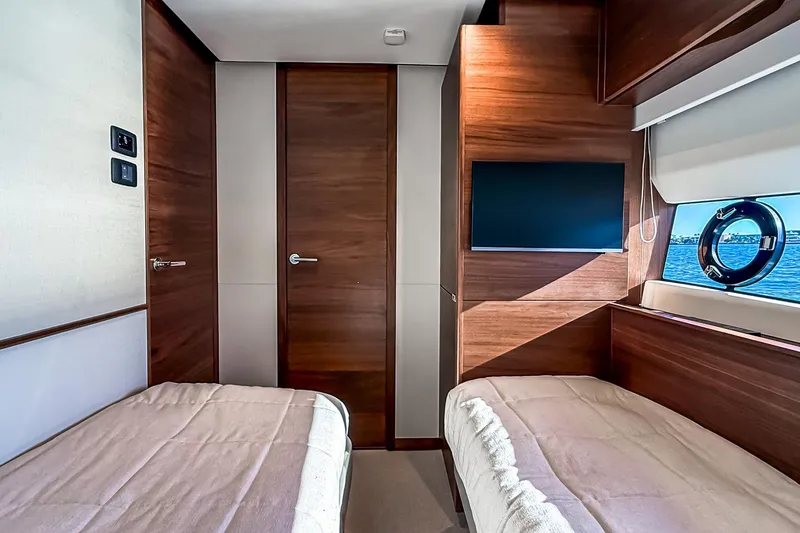 Slide: The Image of Luxurious cabin interior of 2026 Princess S65 Sportbridge yacht with twin beds and ocean view. - 70