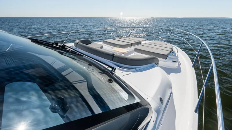 Slide: The Image of 2025 Princess S65 Sportbridge yacht cruising on open sea under clear skies. - 80