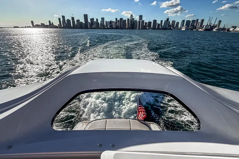 Slide: The Image of 2026 Princess S65 Sportbridge yacht cruising with city skyline in the background. - 81