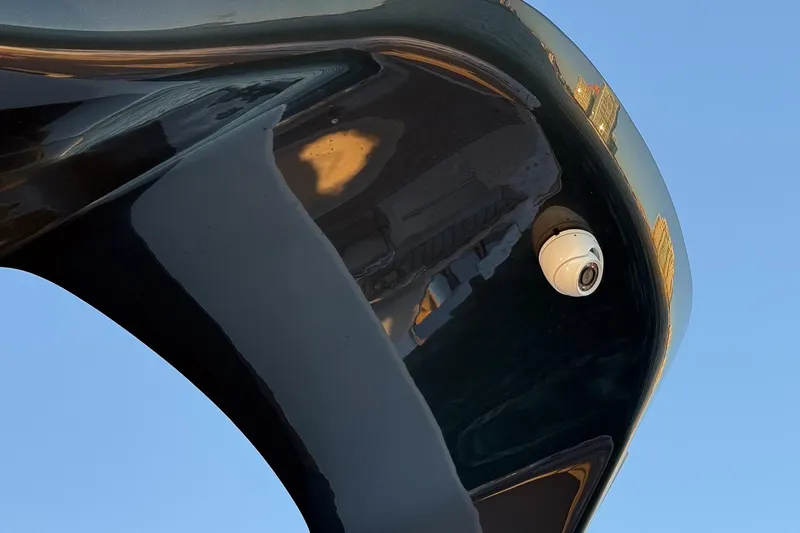 Slide: The Image of 2026 Princess S65 Sportbridge yacht with sleek black hull and security camera. - 82