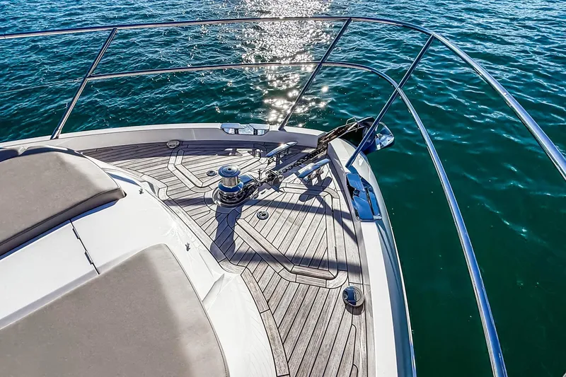 Slide: The Image of Bow of 2026 Princess S65 Sportbridge yacht on sparkling blue water. - 88