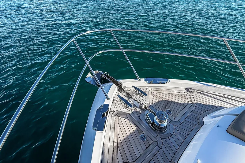 Slide: The Image of Bow of 2026 Princess S65 Sportbridge yacht on clear blue water. - 89