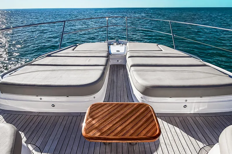 Slide: The Image of Luxurious 2026 Princess S65 Sportbridge yacht deck with sun loungers and ocean view. - 91