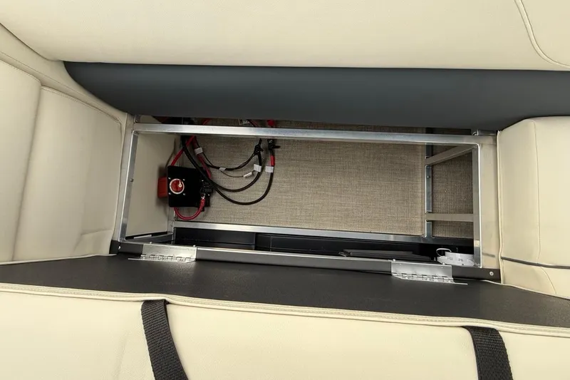 Slide: The Image of 2026 Avalon VLS Quad Lounge storage compartment with visible wiring and battery switch. - 12