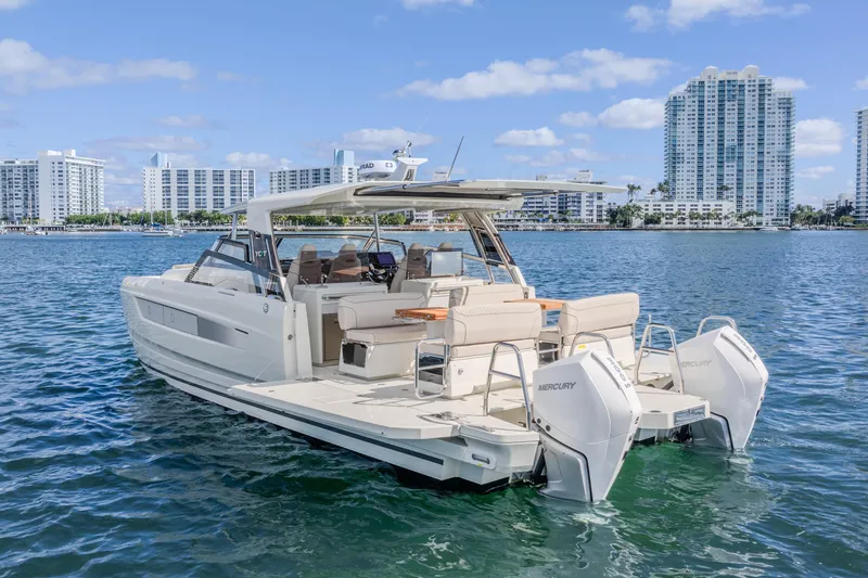 Slide: The Image of Modern Catana YOT 36 boat on water, city skyline in background, 2025 model. - 11