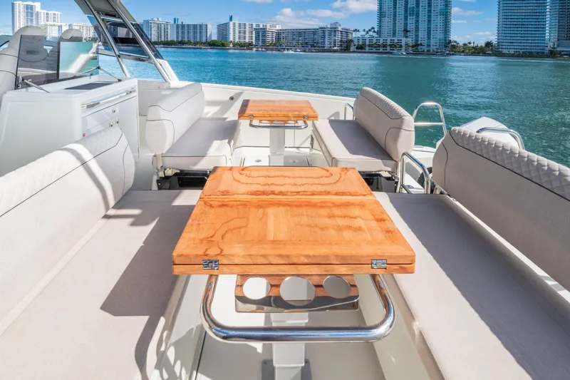Slide: The Image of Luxurious Catana YOT 36 yacht interior with wooden tables, overlooking a scenic waterfront. - 14