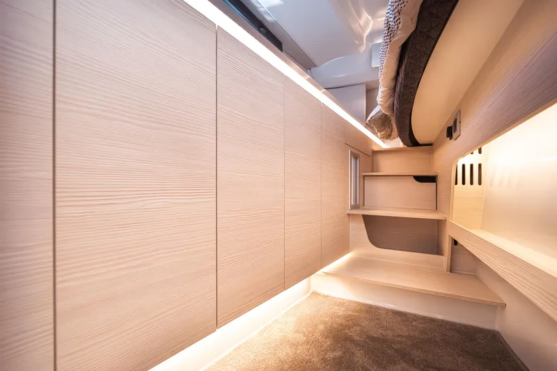 Slide: The Image of Modern interior of 2025 Catana YOT 36 yacht with sleek wooden cabinetry and cozy carpeted flooring. - 37
