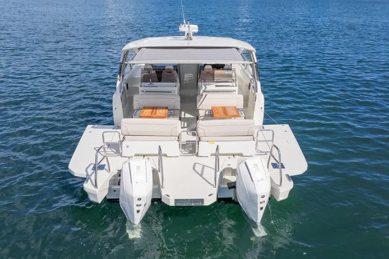 Slide: The Image of 2025 Catana YOT 36 boat on water, rear view with twin engines and seating area. - 9