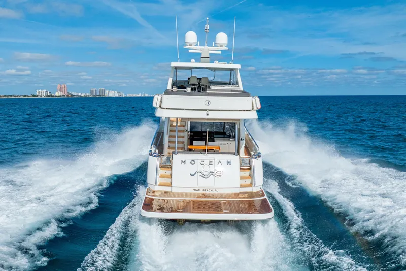 Slide: The Image of 2021 Ocean Alexander 70E Motoryacht cruising on open sea near Miami Beach. - 10