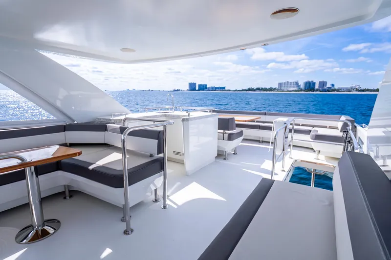 Slide: The Image of Luxurious 2021 Ocean Alexander 70E Motoryacht deck with seating, ocean view, and city skyline. - 18